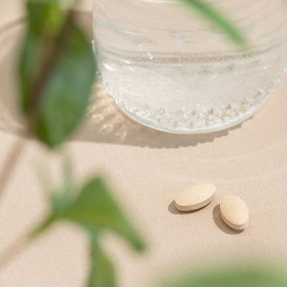 Ashwagandha Tablets next to water glass