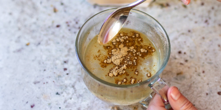 cup of water with powdered triphala