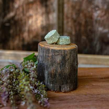 clarifying tulsi tablets on a wooden block with a natural background